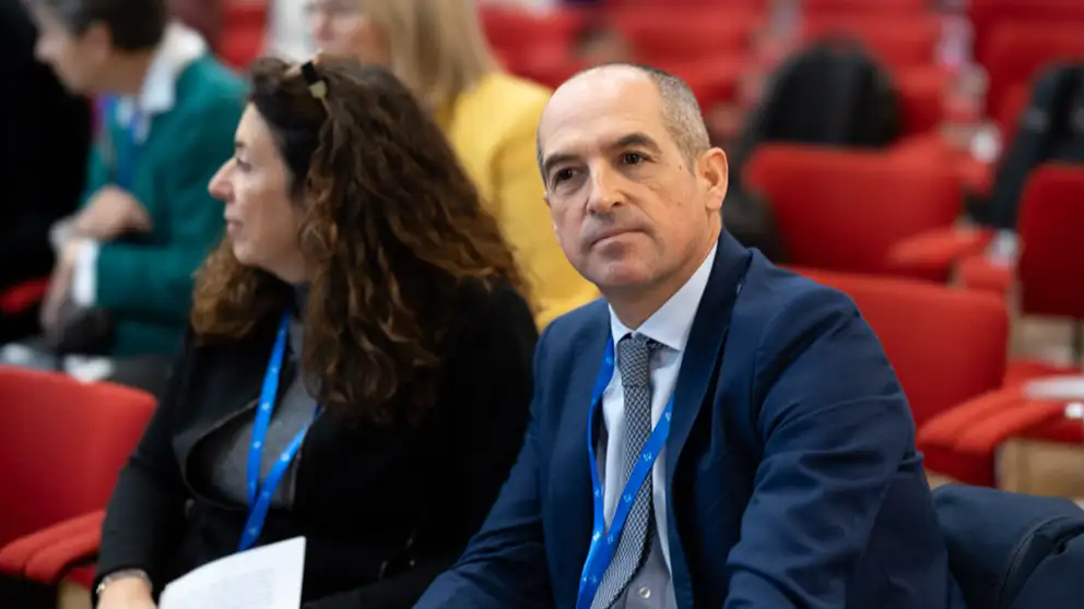 Man and woman listering to presenter