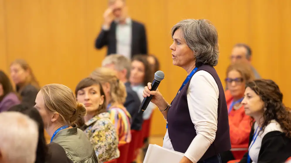 Woman asking question with microphone