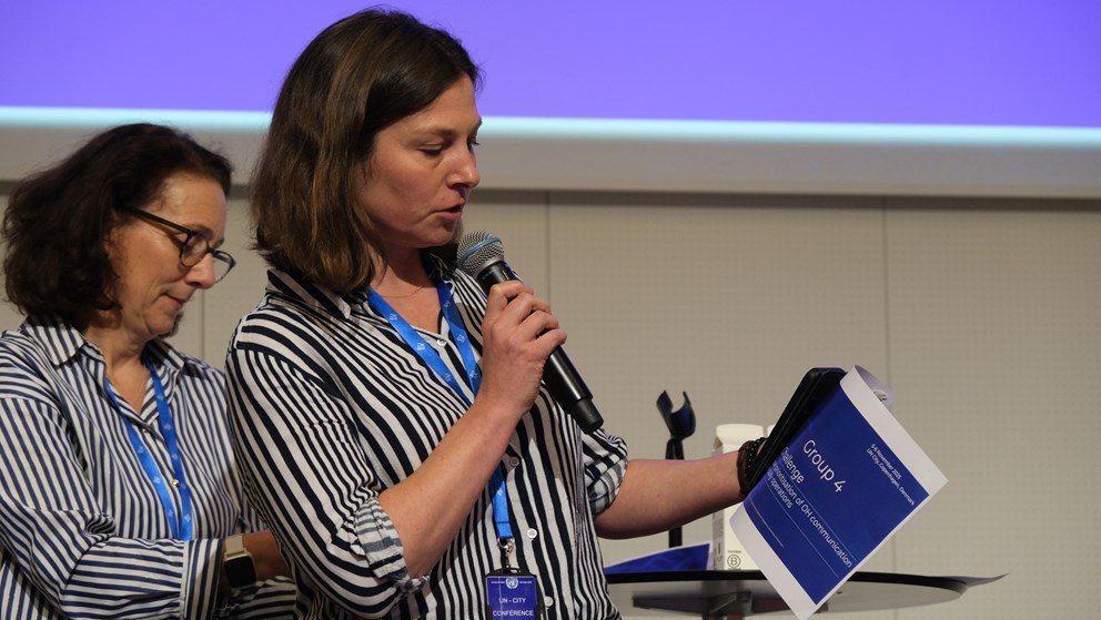 Woman presenting and looking on a paper in her hand