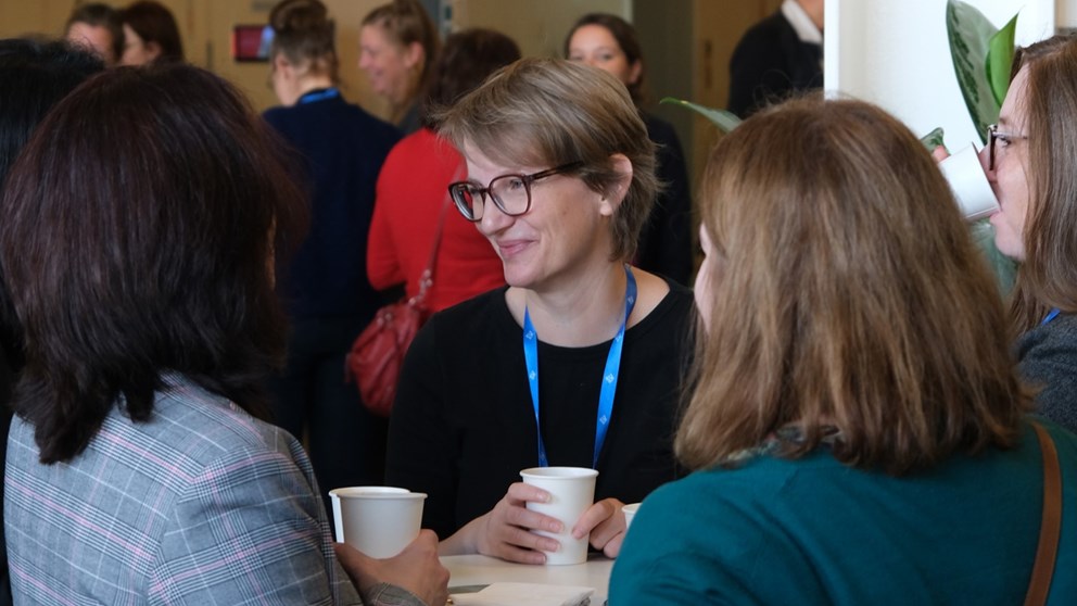 Four women drinking coffee and networking